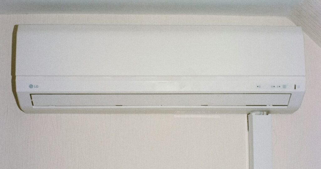 壁に取り付けられたエアコンのリモコン操作